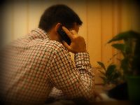 Zdjęcie przedstawia mężczyznę rozmawiającego przez telefon.