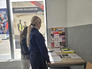 Zdjęcie przedstawia umundurowaną policjantkę oraz kobietę w siedzibie komendy w Sosnowcu.