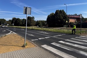 Zdjęcie przedstawia umundurowaną policjantkę podczas czynności służbowych.