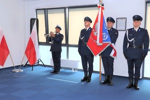Zdjęcie przedstawia umundurowanych policjantów ze sztandarem Komendy Miejskiej Policji w Sosnowcu.
