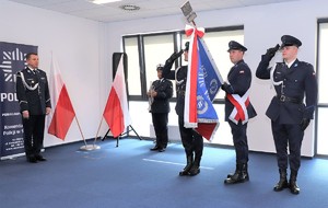Zdjęcie przedstawia umundurowanych policjantów ze sztandarem Komendy Miejskiej Policji w Sosnowcu.