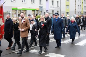 Zdjęcie przedstawia uczestników uroczystości podczas przemarszu.