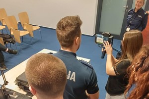 Zdjęcie przedstawia policjanta z wydziału ruchu drogowego prezentującego sprzęt służbowy.