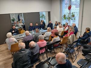 Umundurowali policjanci podczas debaty społecznej z mieszkańcami.